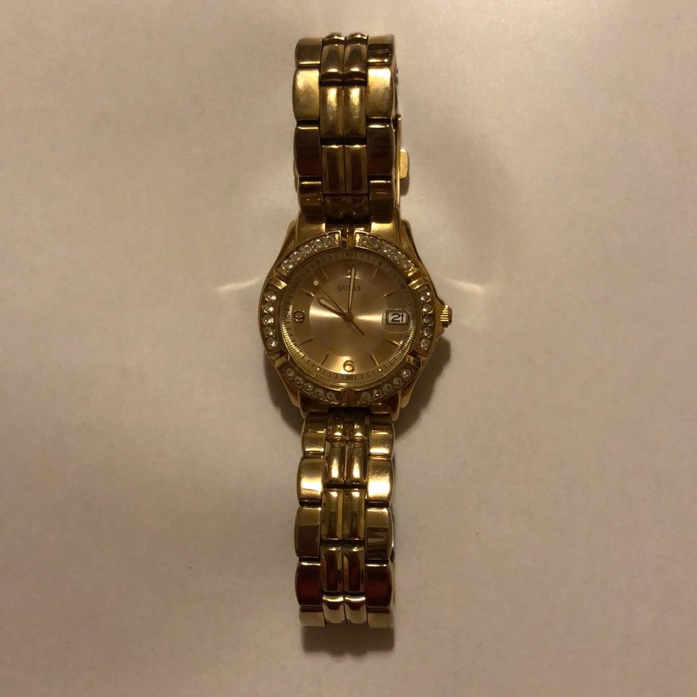 woman’s gold watch Guess